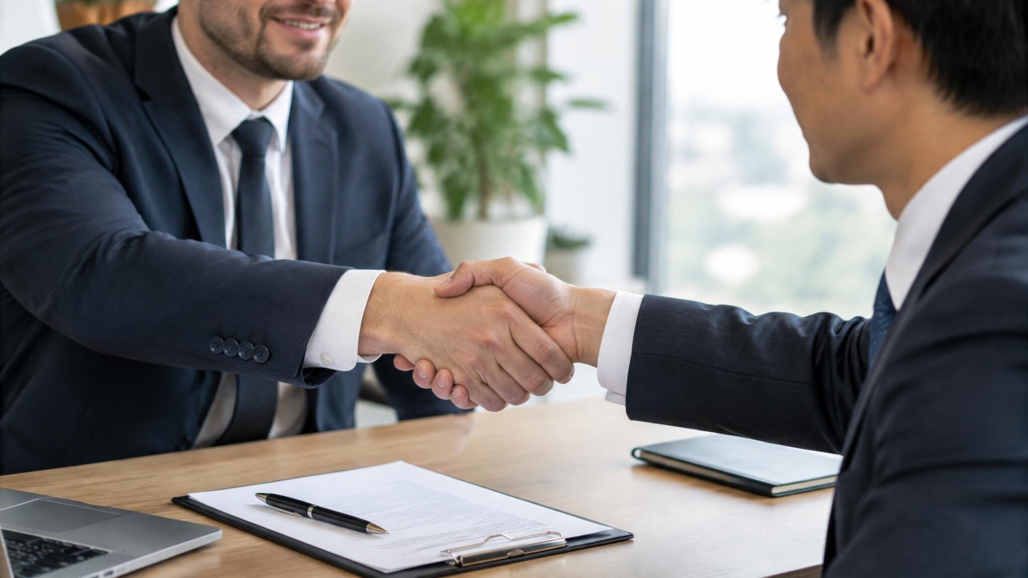 Close-up of two people shaking hands after a successful negotiation